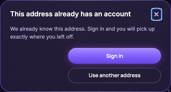 A dialog saying this address already has an account, with a Sign in button and a Use another address button
